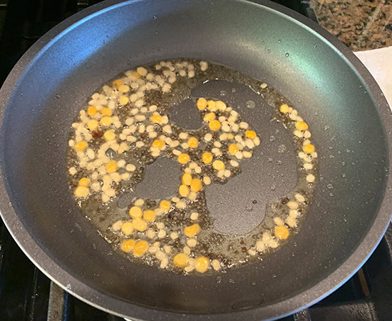 lentils being added to a pan