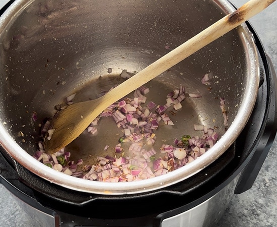 chopped onion with spices getting sauteed in instant pot