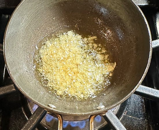chopped garlic in a small pan with ghee