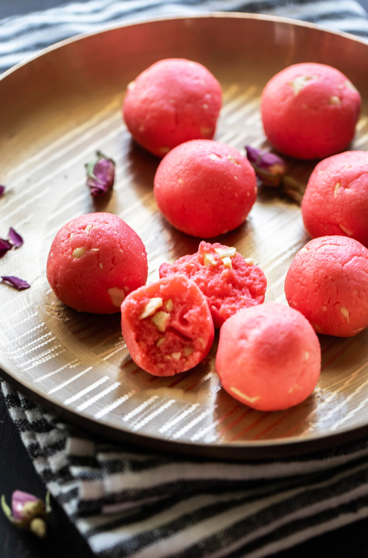 rose ladoo being broken in half to show inside texture