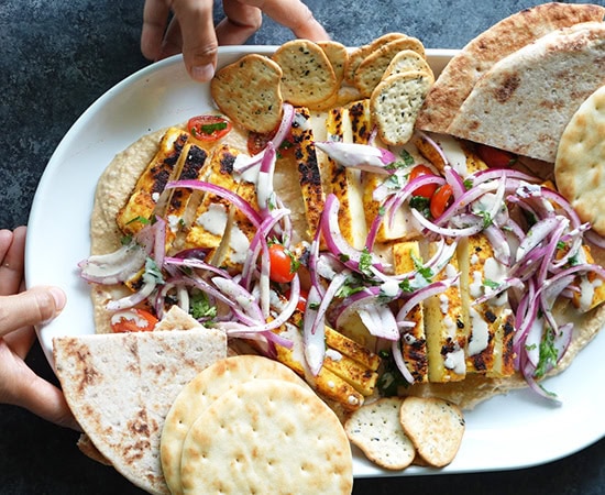 hummus with paneer, onions, with naan pieces on the side