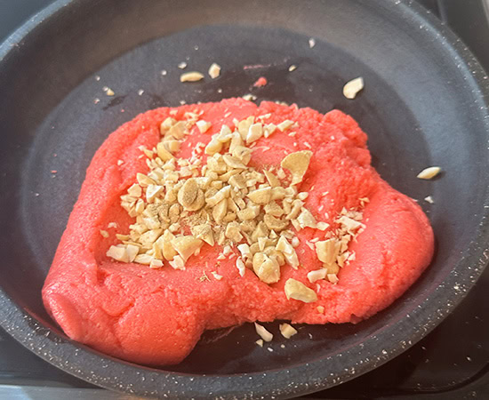 pink color ladoo mixture in a bowl