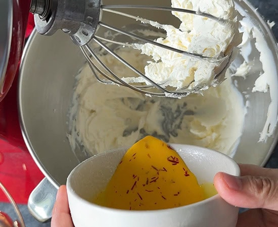 saffron milk being added to a stand mixer