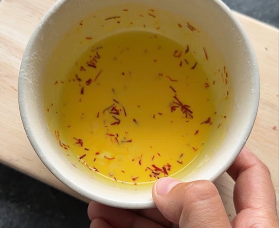 saffron soaked in milk in a bowl