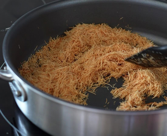 shredded kataifi being roasted in a pan