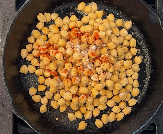 chickpeas with spices in an iron pan