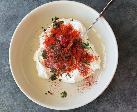 bowl with sour cream and spices added to it