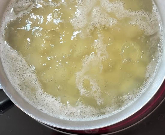 cubed potatoes being boiled in water