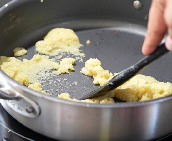 spatula stirring mawa in a pan