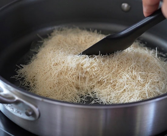 shredded kataifi being roasted in a pan