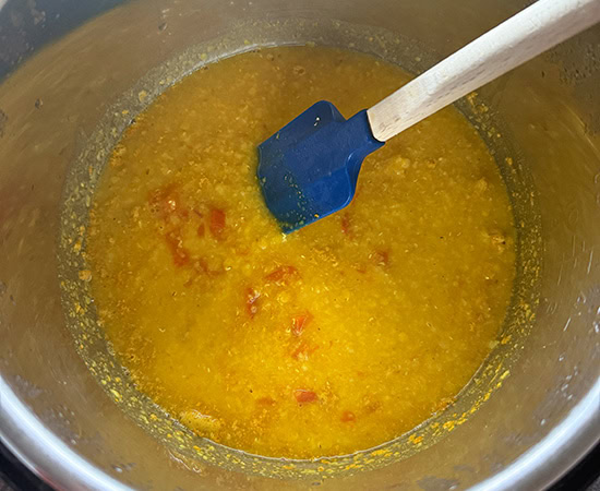 pressure cooked dal in instant pot with blue spatula on the side